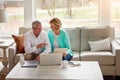 Taking care of their monthly budget together. a mature couple going over their finances at home. Royalty Free Stock Photo