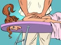 Taking care of your health. Salon of high-quality and professional massage. Woman on a massage table, hands of a male