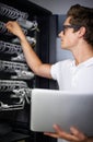 Taking care of your network needs. A computer technician fixing a server.