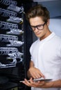 Taking care of your network needs. A computer technician fixing a server.