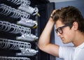 Taking care of your network needs. A computer technician scratching his head.