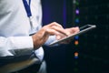 Taking charge of big data. Closeup shot of an unrecognisable man using a digital tablet while working in a server room. Royalty Free Stock Photo