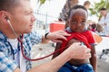 Taking a closer listen to his heart. a volunteer doctor giving checkups to underprivileged kids.
