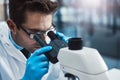 Taking a closer look. a young male scientist working in a lab with a microscope. Royalty Free Stock Photo