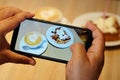 Taking coffee and bread with banana photo by smartphone camera Royalty Free Stock Photo