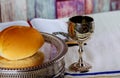 Taking Communion. Cup of glass with red wine, bread and Holy Bible on wooden table close-up. Royalty Free Stock Photo