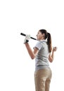 Taking control of her club. Studio shot of a young golfer holding a golf club behind her back isolated on white. Royalty Free Stock Photo