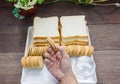 Taking cookie in hand with bread background Royalty Free Stock Photo