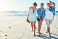 Taking a family stroll on the beach. Full length shot of a senior woman spending the day at the beach with her daughter Royalty Free Stock Photo