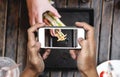 Taking food photo, food photography by smart phone, club sandwich with french fries on wooden table Royalty Free Stock Photo