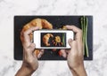 Taking food photo, food photography by mobile smart phone, Homemade Croissant with Scrambled Eggs Royalty Free Stock Photo