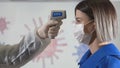 Taking a girl`s temperature with thermometer to find coronavirus, Covid-19. Close up shot. Royalty Free Stock Photo