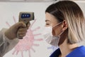 Taking a girl`s temperature with thermometer to find coronavirus, Covid-19. Close up shot. Royalty Free Stock Photo