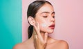 Taking good care of her skin. Beautiful woman spreading cream on her face. Skin cream concept. Facial care for female Royalty Free Stock Photo