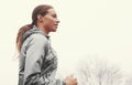 Taking her run one step at a time. A young woman jogging on a country road on a misty morning. Royalty Free Stock Photo