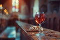 Taking holy communion at a wooden table in a church. Red wine and bread in the cup of a glass. Corpus Christi concept. Royalty Free Stock Photo