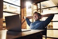 Taking the laid-back approach to business. a handsome young male designer looking relaxed while working late in his Royalty Free Stock Photo