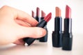 Taking a lipstick: Female hand is taking an elegant, red lipstick