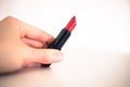 Taking a lipstick: Female hand is taking an elegant, red lipstick
