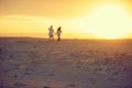 Taking a long walk together. Rearview shot of an affectionate mature couple walking hand in hand on the beach. Royalty Free Stock Photo