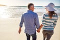 Taking a lovely stroll on the beach. a mature couple spending the day at the beach. Royalty Free Stock Photo