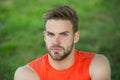 Taking minute break. Runner relaxing in shadow. Man with bristle strict face, grass background. Man unshaven looks Royalty Free Stock Photo