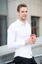 Taking moment enjoy day. Man well groomed white shirt drinks coffee urban background. Businessman relaxing with coffee