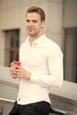 Taking moment enjoy day. Man well groomed white shirt drinks coffee urban background. Businessman relaxing with coffee