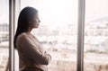 Taking a moment to ponder her goals. a mature businesswoman looking out a window in an office. Royalty Free Stock Photo