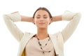 Taking a moment to reflect. A beautiful young businesswoman leaning back with her hands behind her head isolated on Royalty Free Stock Photo