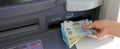 taking money from automatic teller machine in european twenty euro banknotes