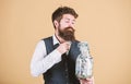 Taking money for doing business. Businessman taking money out of glass jar. Bearded man putting investing money in Royalty Free Stock Photo