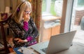 Woman on laptop,working from home, watching a webinar Royalty Free Stock Photo