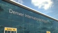 Taking off airplane reflecting in the modern windows with Denver International Airport text, 3d rendering