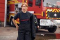 Taking off the protective clothes. Woman firefighter in uniform is at work in department Royalty Free Stock Photo