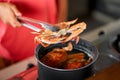 Taking out cooked blue crab from pot with boiling water Royalty Free Stock Photo