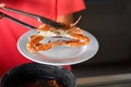 Taking out fresh cooked blue crab from pot and put it on white plate Royalty Free Stock Photo