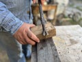 Taking out the nail from the wooden boards.