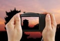 Taking a Photo of an Asian Temple at Sunset