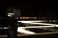 Taking photo of with camera mounted on tripod. Blurred view of city lights at night, bokeh effect Royalty Free Stock Photo