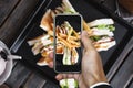 Taking photo of club sandwich, top view by mobile smart phone Royalty Free Stock Photo