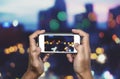 Taking photo by smart phone, Hands holding smartphone taking Bokeh lights Royalty Free Stock Photo