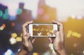 Taking photo by smart phone, Hands holding smartphone taking Bokeh lights Royalty Free Stock Photo