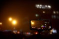 Taking photo of with smartphone mounted on tripod. Blurred view of city lights at night, bokeh effect Royalty Free Stock Photo