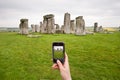 Taking photo for stonehenge with cell phone Royalty Free Stock Photo