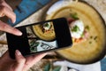 Taking photo of toast with poached eggs, bacon, beans Royalty Free Stock Photo