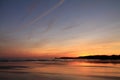 Taking photos of scenic view just before sunrise of silhouette deux jumeaux in colorful summer sky on a sandy beach