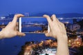 Taking picture of Sai Van Bridge at night in Macau with smartphone Royalty Free Stock Photo