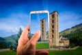 Taking a picture with a smartphone inBelfry and church of Sant Climent de Taull, Catalonia, Spain Royalty Free Stock Photo