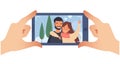 Taking a picture on a smartphone. Smiling couple. Horizontal photo. Hands holding smartphone